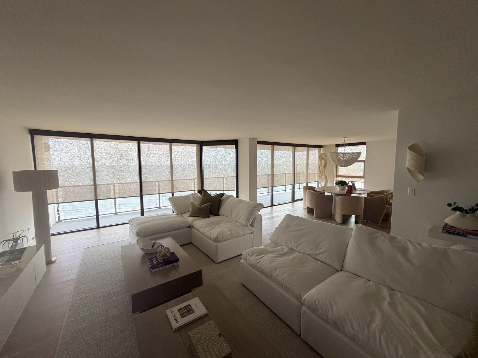 Oceanfront Jacksonville living room with solar shades across a full wall of glass
