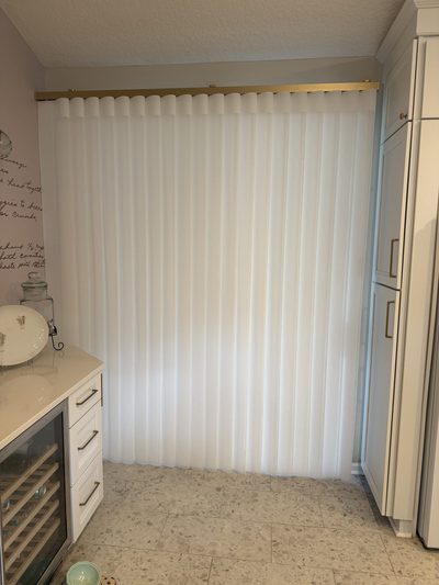 Sheer vertical blinds across a patio slider